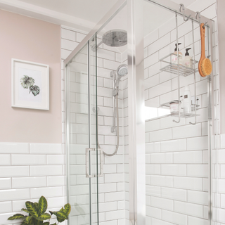 A white metro tiled shower cubicle with chrome frame