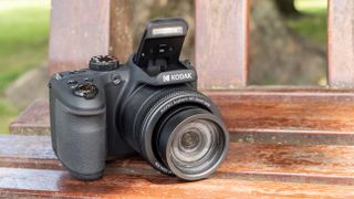 Kodak PixPro AZ405 digital camera in black on a wooden slatted table