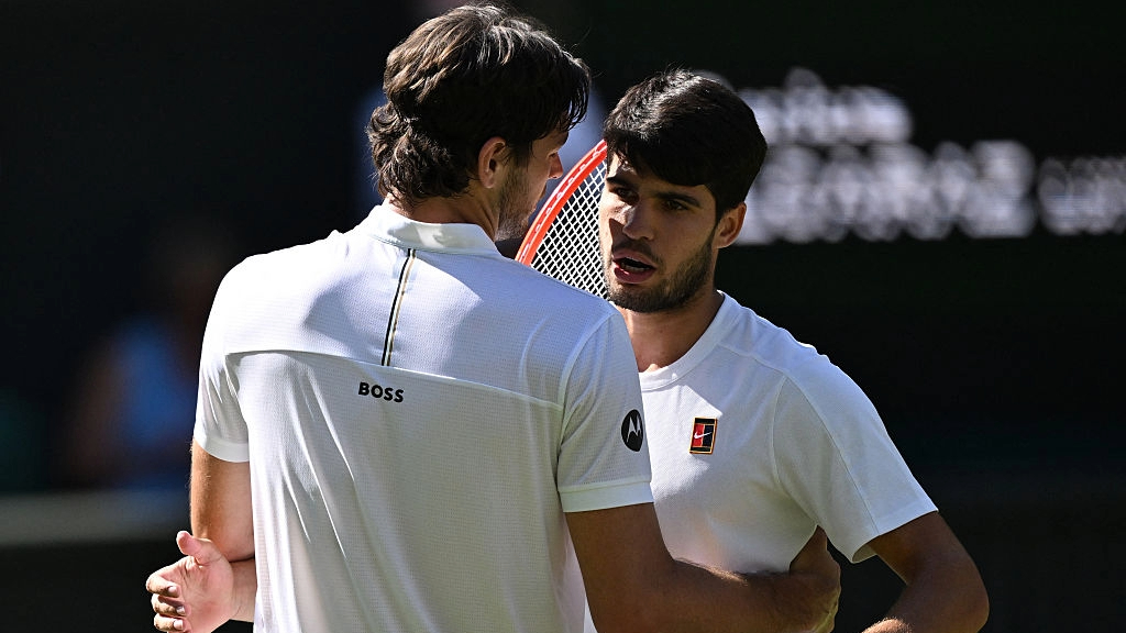 Carlos Alcaraz is congratulated by Taylor Fritz after winning their Wimbledon 2025 men's singles semifinal