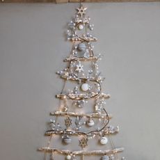 grey wall with tree ladder and baubles