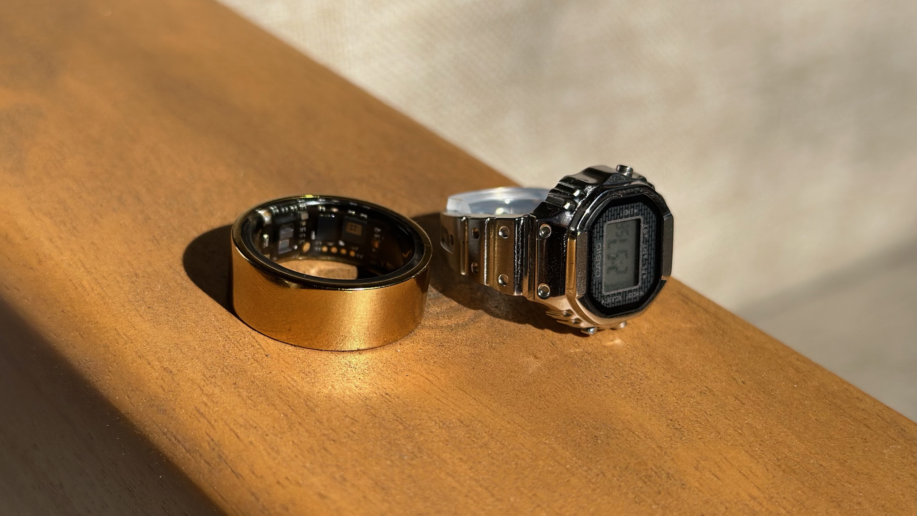 A close-up of the Ultrahuman Ring Air (left) and Casio CRW001-1 ring watch (right)