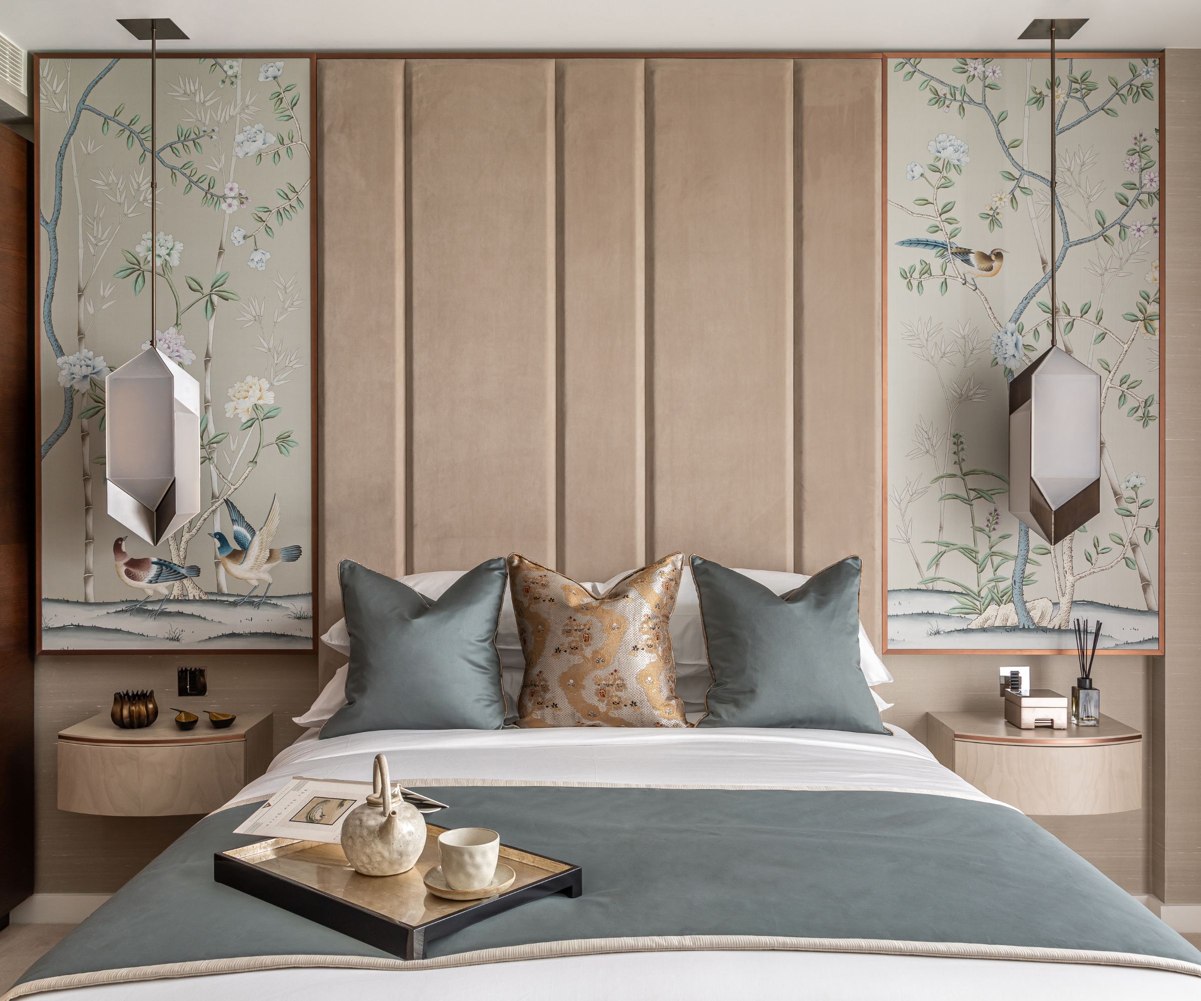 Pink headboard, tree and bird paintings, blue bedding