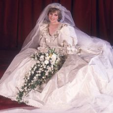 Princess Diana in her wedding dress sitting on the floor
