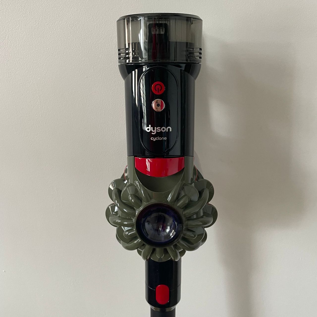 Close-up shot of the Dyson V8 Cyclone main unit with on/off controls and handle