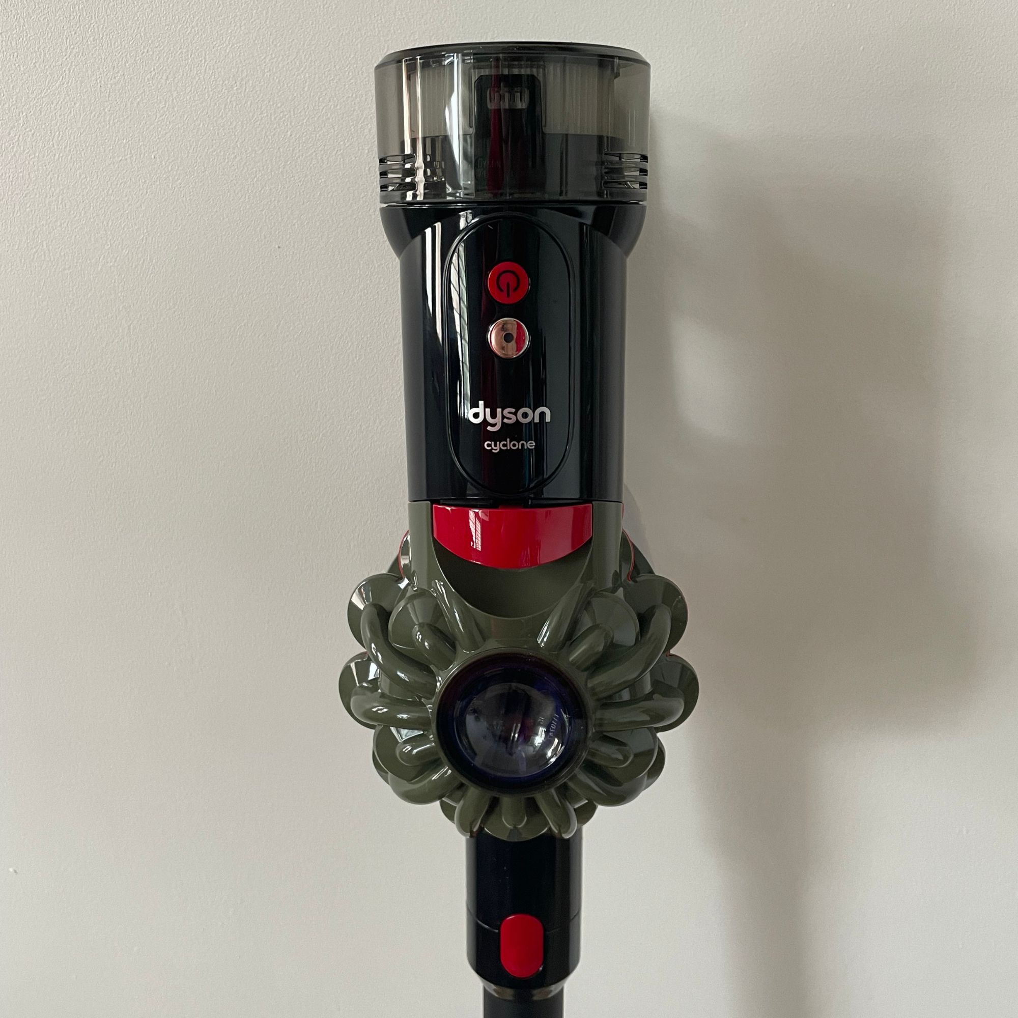 Close-up shot of the Dyson V8 Cyclone main unit with on/off controls and handle