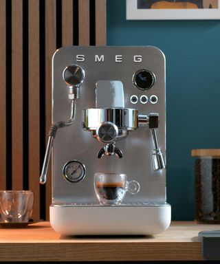 A silver espresso machine from Smeg