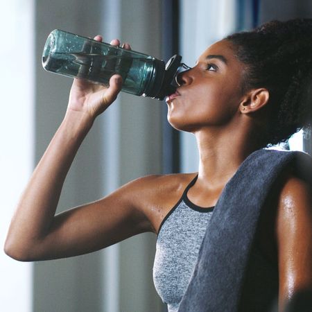 Free weight exercises: A woman at the gym in the weights section