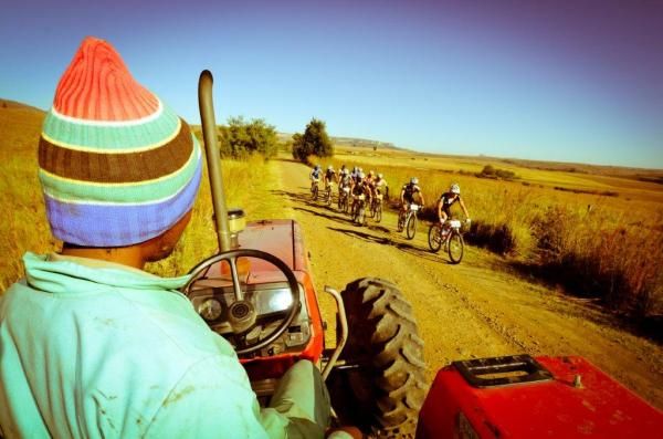 A local farm worker looks on as the leaders pass by
