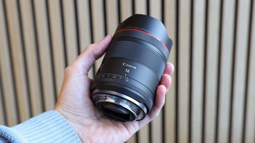 Canon RF 14mm f/1.4L VCM lens held in a hand