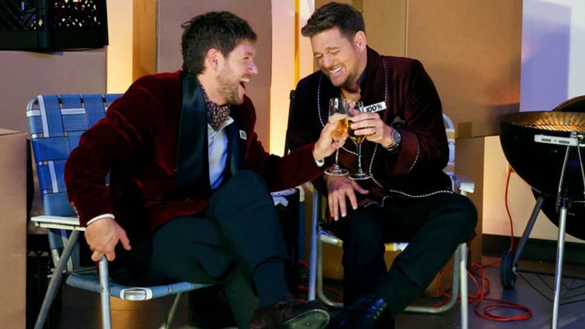 Niall Horan and Michael Buble laugh and cheers to being undefeated on The Voice during Season 28.