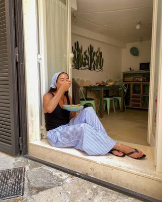 woman in stripe pants and black top