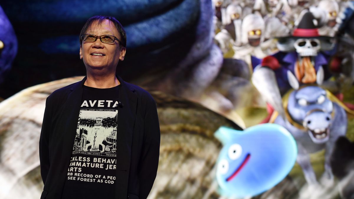 Yuji Horii, creator of Dragon Quest, smiles next to some characters from the series.