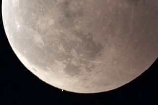 Photo taken in Nagoya, central Japan, on Nov. 8, 2022, shows a lunar occultation of Uranus (seen at the bottom of the moon.)