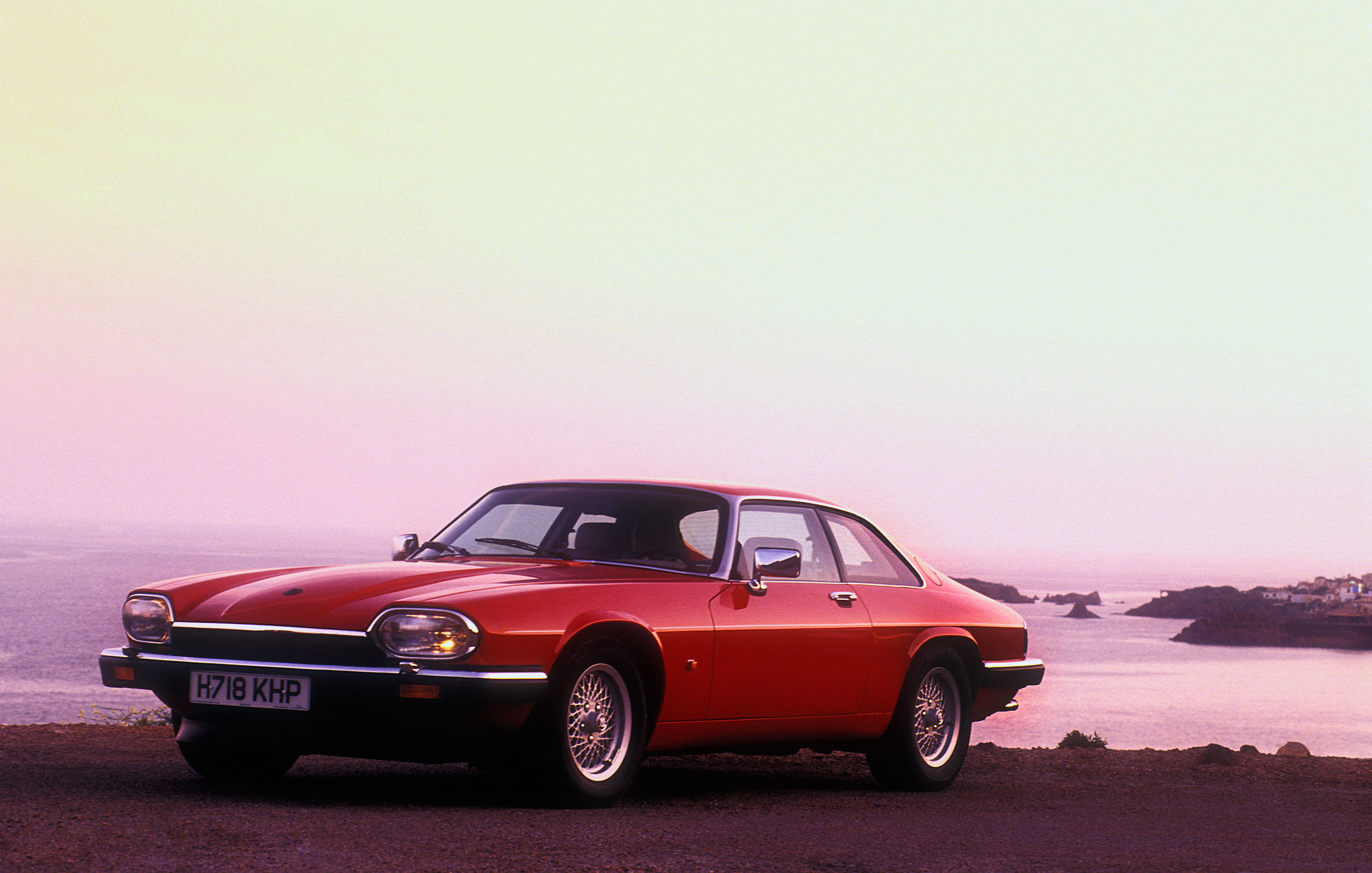 A red Jaguar XJS in a suitably 1980s setting