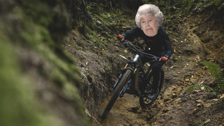 A comedic photo of a mountain biker with the Queen's face superimposed