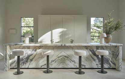 A kitchen with fluted marble island 