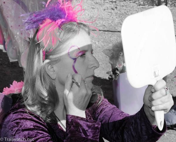 A woman getting ready at the face painting booth