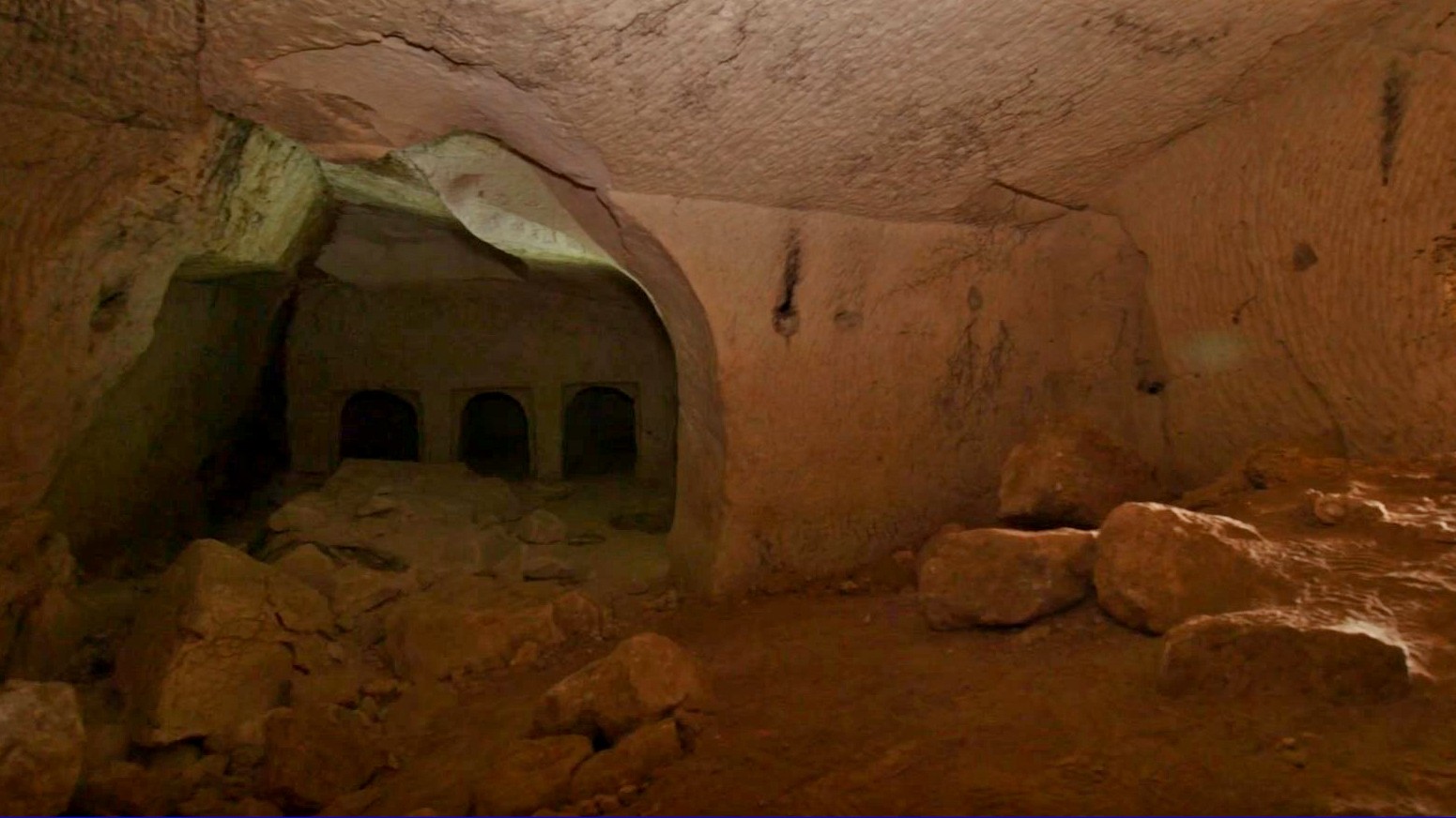 Here we see in inside of Salome's cave. There is a circular entrance on the left which leads to three rectangular doorways.
