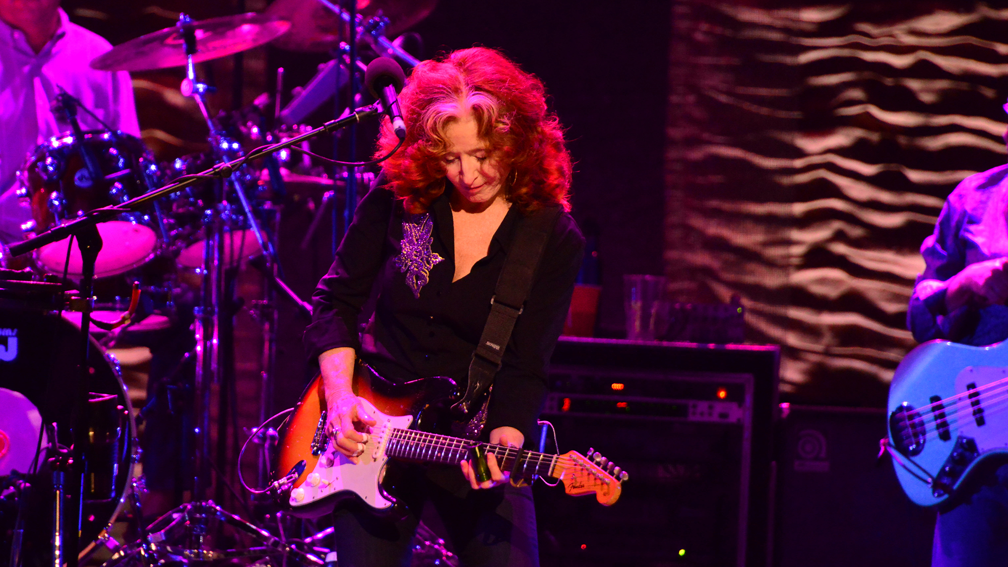 LONDON, UNITED KINGDOM - JUNE 27: American blues rock guitarist Bonnie Raitt (R) and drummer Ricky Fataar performing live on stage at the Royal Albert Hall in London, on June 27, 2013