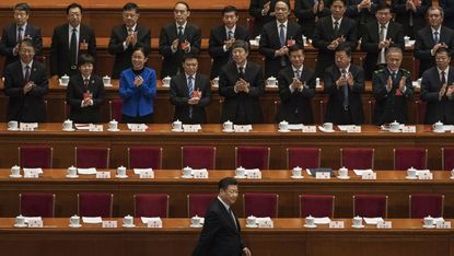 President Xi Jinping is applauded as he arrives at a session of the National People's Congress