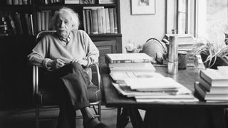 Einstein sitting at his desk
