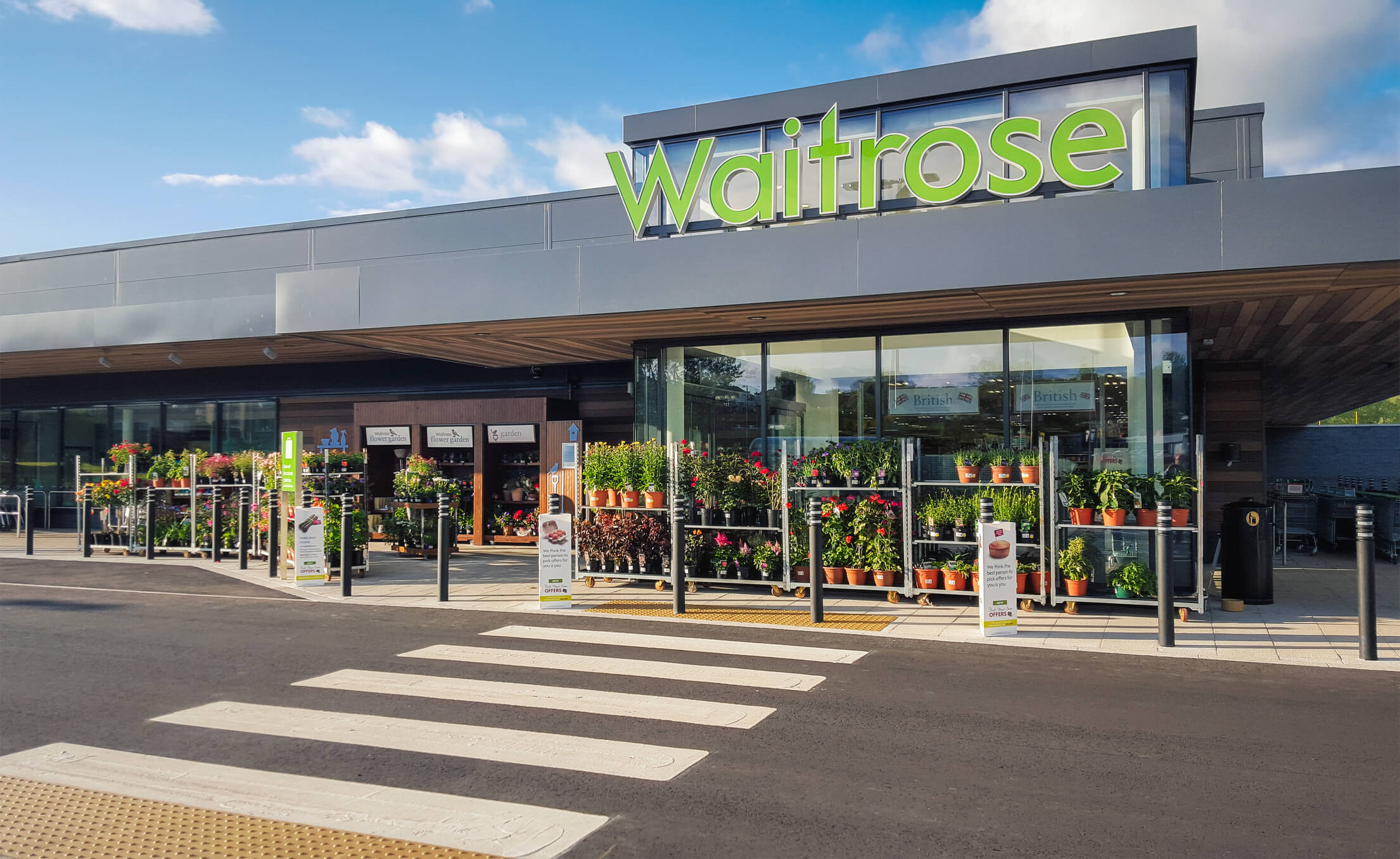 The front entrance and facade of a Waitrose supermarket in Milngavie, Glasgow.