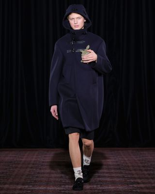 A navy duffel coat at Simone Rocha Fall 2025 runway show