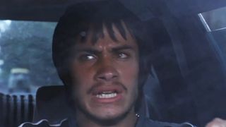a man looking upset while driving a car
