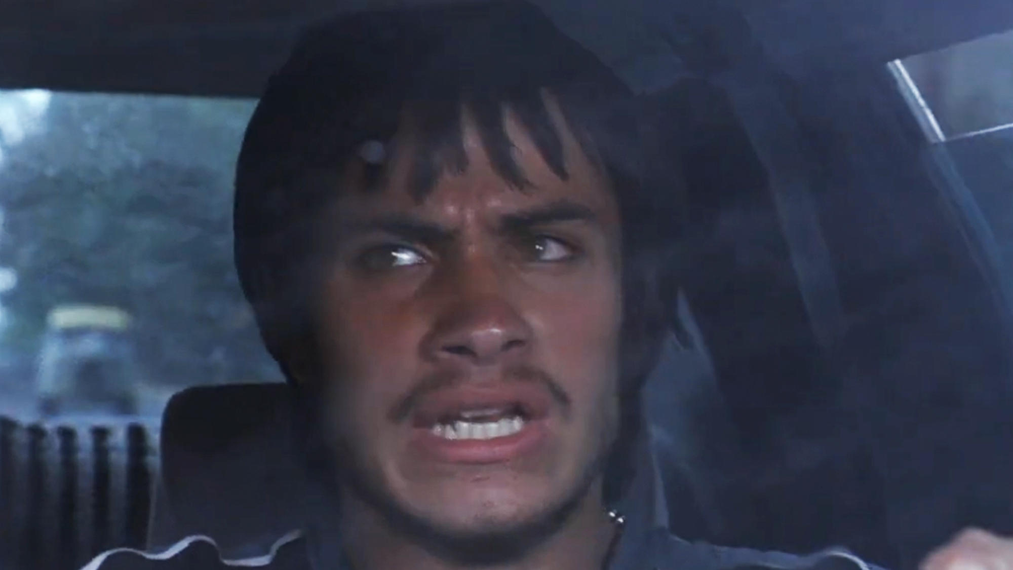 a man looking upset while driving a car