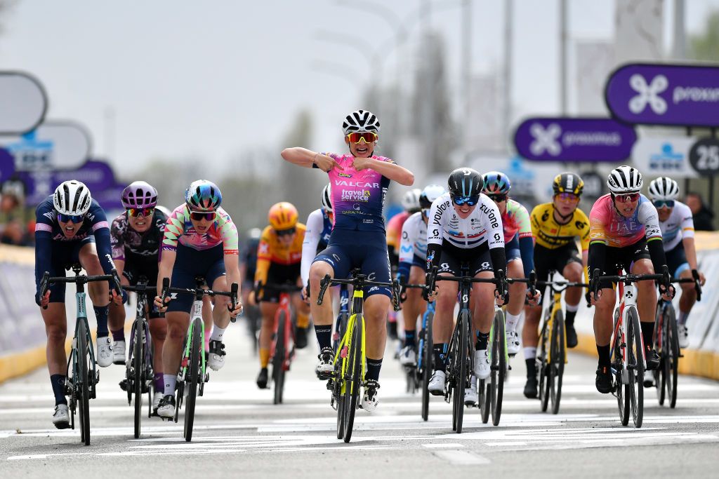 WAREGEM BELGIUM MARCH 30 Chiara Consonni of Italy and Valcar Travel Service Team celebrates winning ahead of Julie De Wilde of Belgium and PlanturPura Team Elise Chabbey of Switzerland and Canyon SRAM Racing Team Pfeiffer Georgi of United Kingdom and Team DSM and Marta Bastianelli of Italy and UAE Team Adq during the 10th Dwars door Vlaanderen 2022 Womens Elite a 120km one day race from Waregem to Waregem DDV22 DDVwomen on March 30 2022 in Waregem Belgium Photo by Luc ClaessenGetty Images
