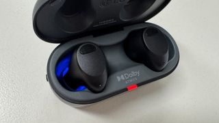 LG ToneFree T90S earbuds case open to show blue UV light inside