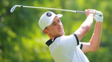 David Puig hits an iron shot