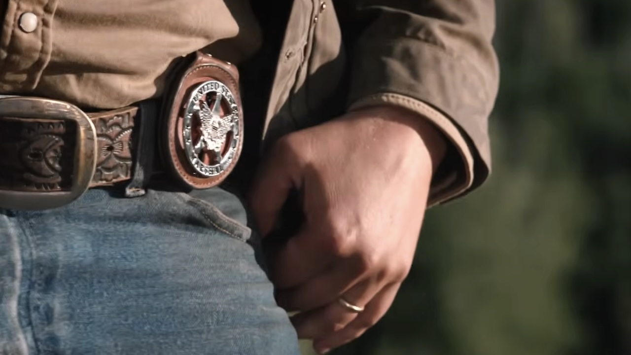 Kayce Dutton's left hand with wedding band on ring finger in Y: Marshals Season 1
