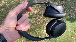 Sennheiser Accentum Plus Wireless noise cancelling over-ears held in hand outdoors
