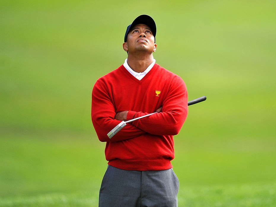 Tiger Woods watches jet airplanes fly overhead during his foursomes match on the first day of the Presidents Cup in 2009