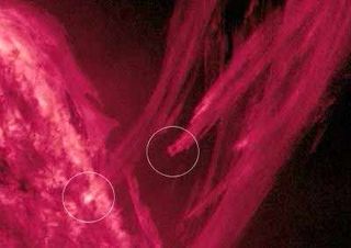 Coronal rain is depicted in this image. Encircled are two plasma streamers hitting the sun’s surface.
