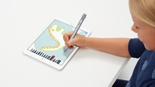 A child using the Logitech Crayon for iPad.
