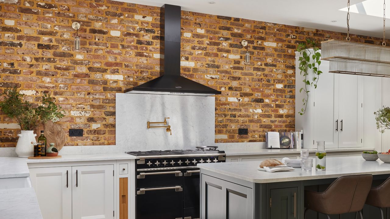 A kitchen with a brick wall and an island