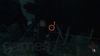 Resident Evil 4 Remake Cargo Depot blue medallion behind a barbed wire fence