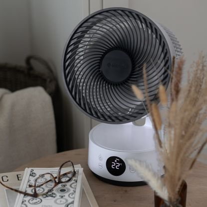Meaco sefte portable fan on a coffee table with books and glasses