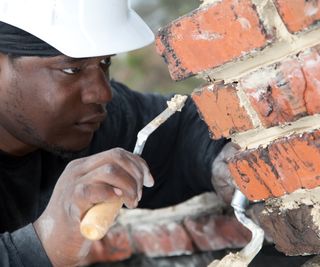 man repointing brickwork