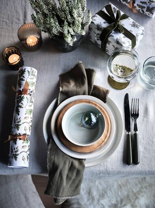 Simple woodland table setting with white tablecloth