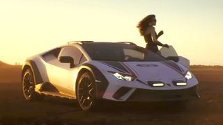 A Lamborghini car with a woman standing next to it