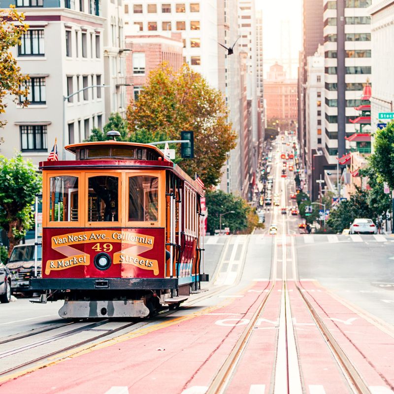 A streetcar moving down a steep street in San Francisco