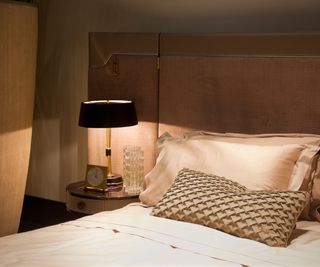 pink bedroom with black bedside lamp