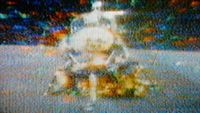 a low resolution television still of a spacecraft blasting off the moon