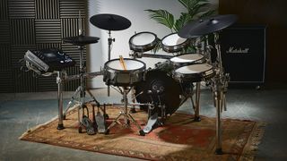 Roland TD-716 e-kit in a rehearsal room with a Marshall cab in the background