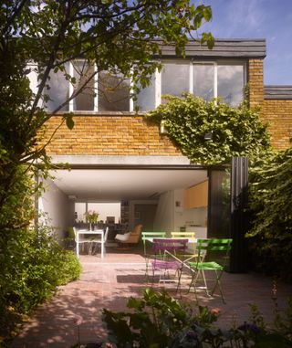 extension clad with brick slips to give contemporary feel in keeping with rest of home photographed by Will Pryce/Arcaid Images