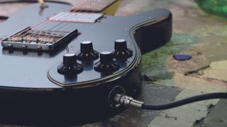 A guitar cable plugged into an electric guitar