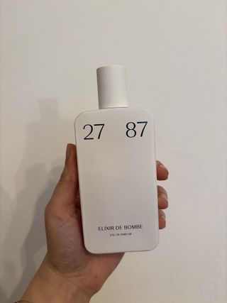 Mica Ricketts holding bottle of 27 87 Elixir De Bombe Eau De Parfum